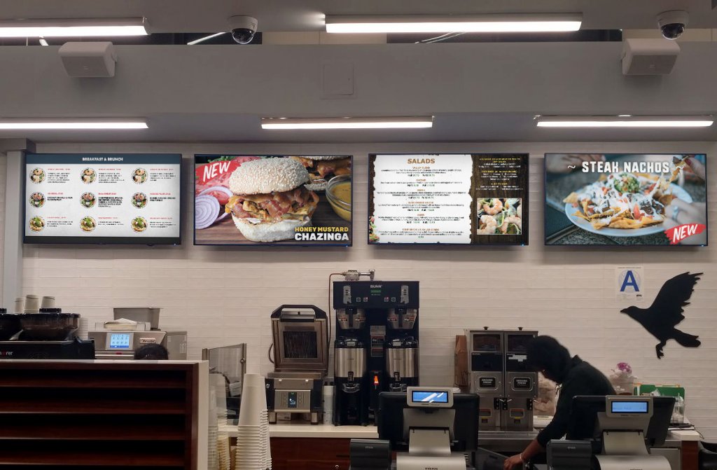 Menu board display above the counter of a Sydney cafe showing menu items and pricing