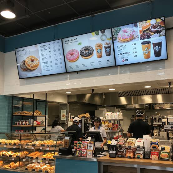 Digital menu display screens showing scheduled menu content in a Sydney hospitality venue