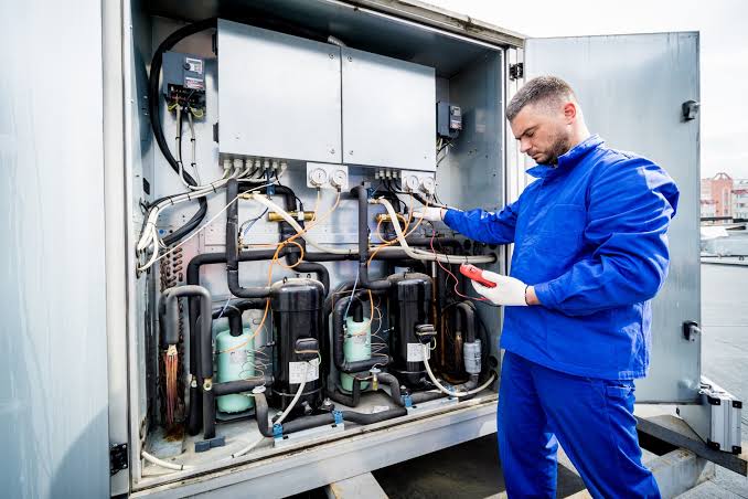 Technician carrying out refrigeration service and maintenance